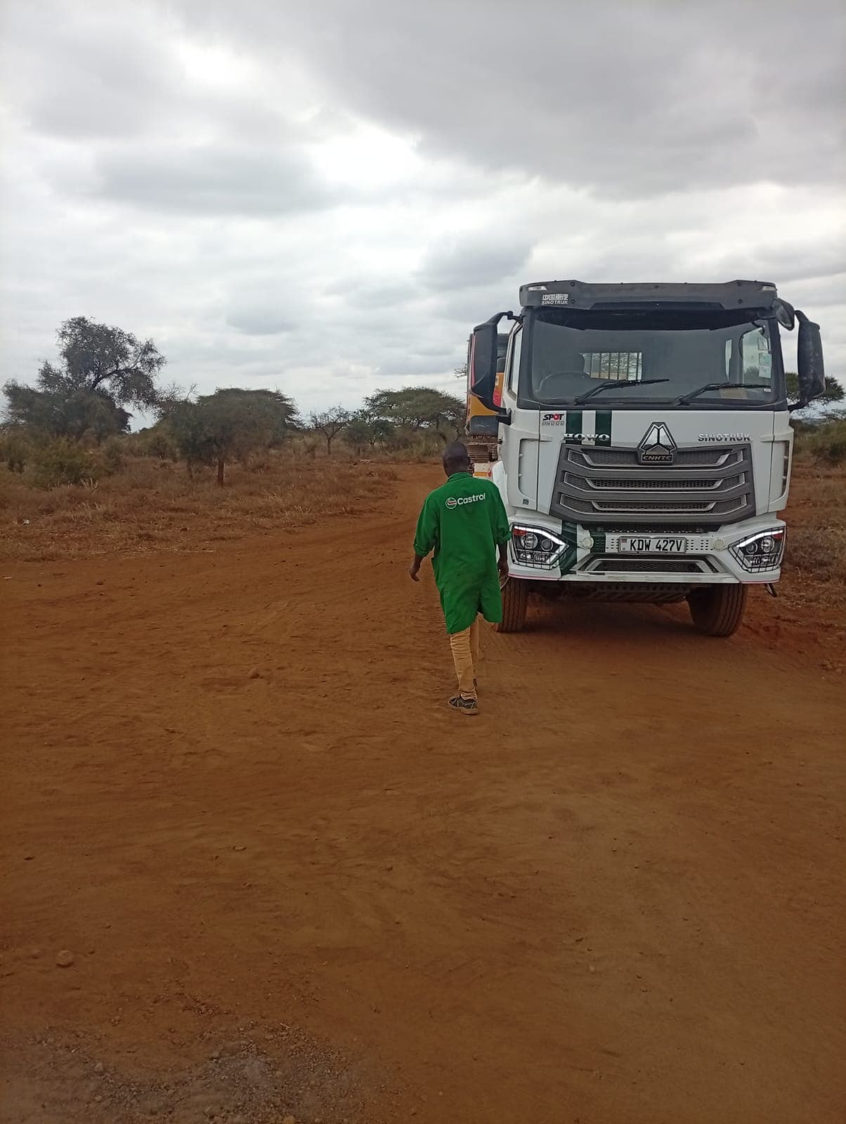 Branded HOWO tipper on a red-soil road