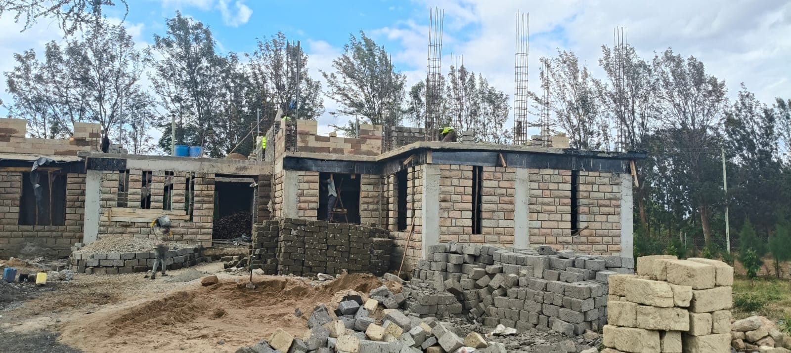 Near-complete house with block walls and roof framing ready